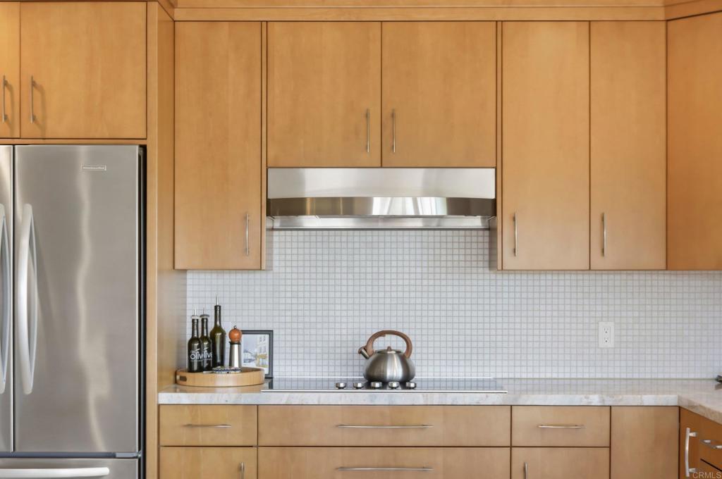 5958 Sagebrush Road La Jolla, CA 92037 - Photo 17 of 64 a kitchen with a sink a refrigerator and cabinets