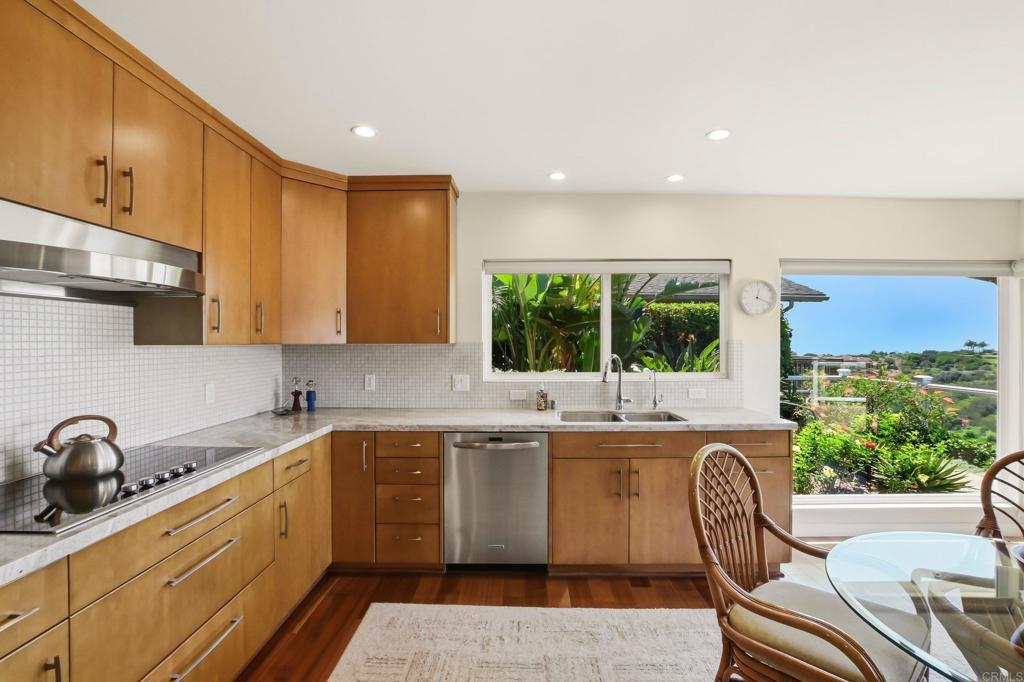 5958 Sagebrush Road La Jolla, CA 92037 - Photo 28 of 64 a kitchen with a sink window and cabinets