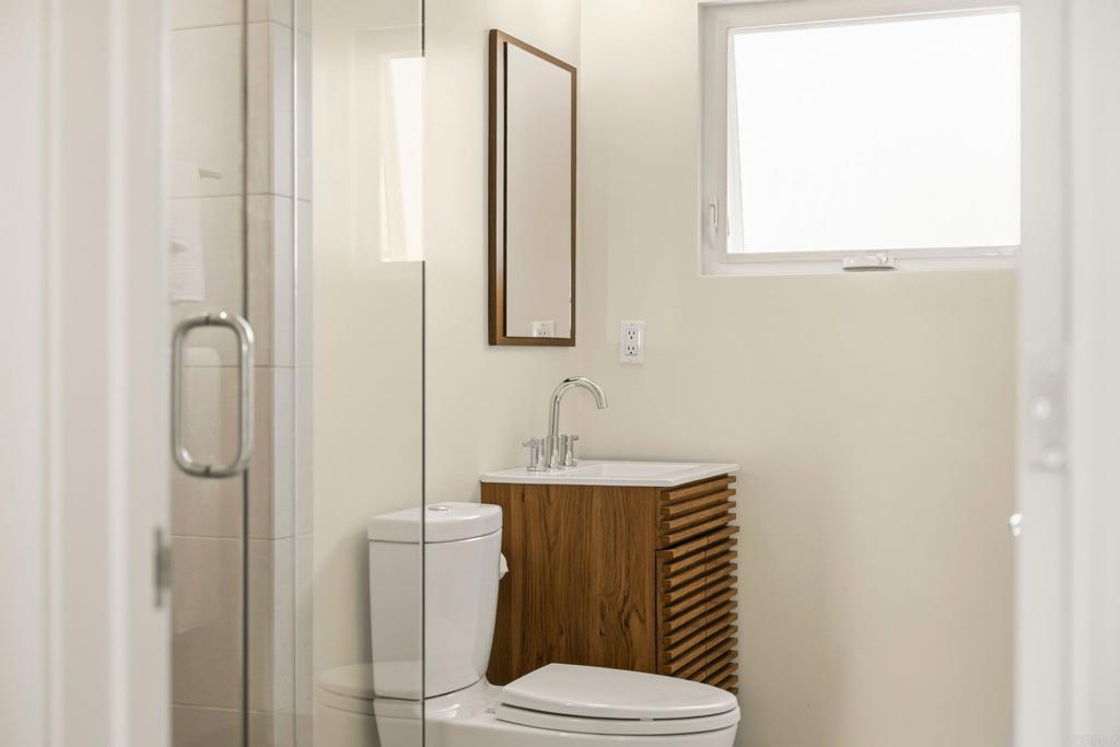 5958 Sagebrush Road La Jolla, CA 92037 - Photo 44 of 64 a bathroom with a sink a toilet and shower