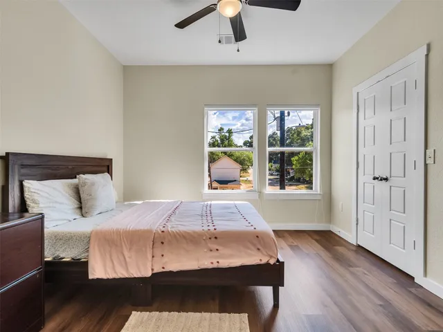 a bedroom with a bed and a large window