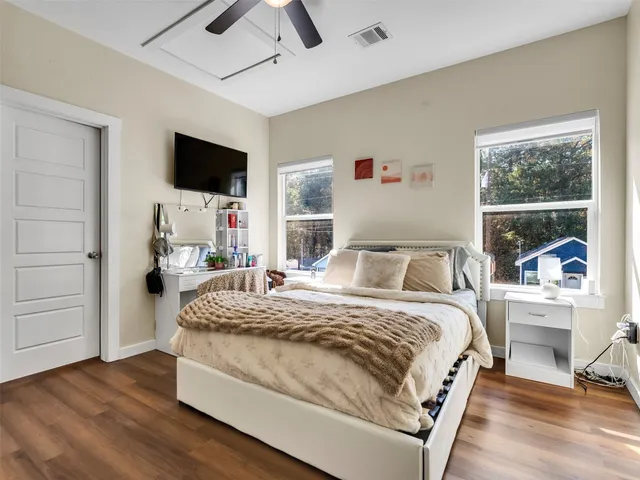 a bedroom with a bed and a flat screen tv