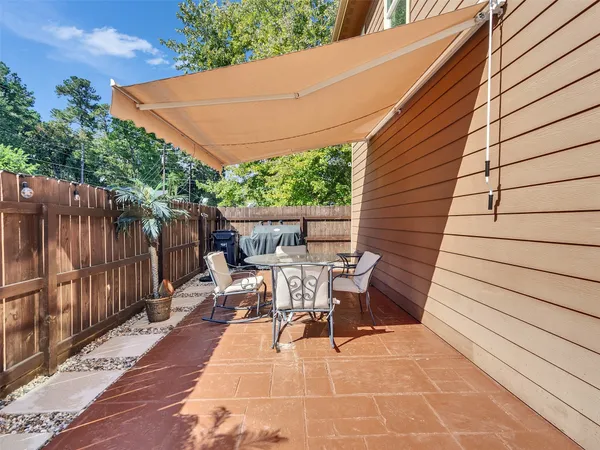 a backyard of a house with outdoor seating