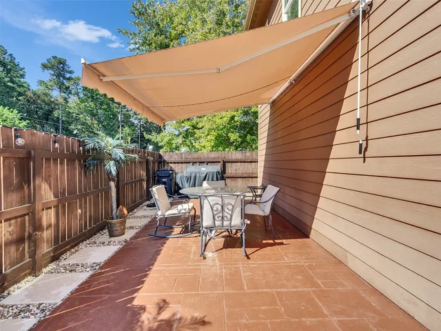 a backyard of a house with outdoor seating