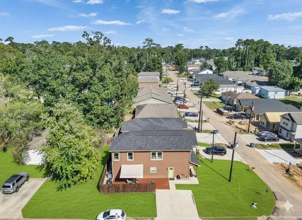 an aerial view of a house with a yard and lake view