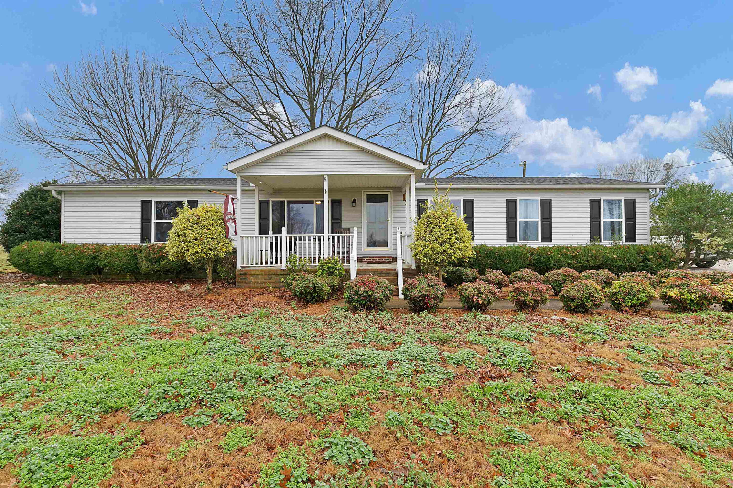 4022 Lower Jackson Road Bells, TN 38006 - Photo 1 of 18 a front view of a house with a garden