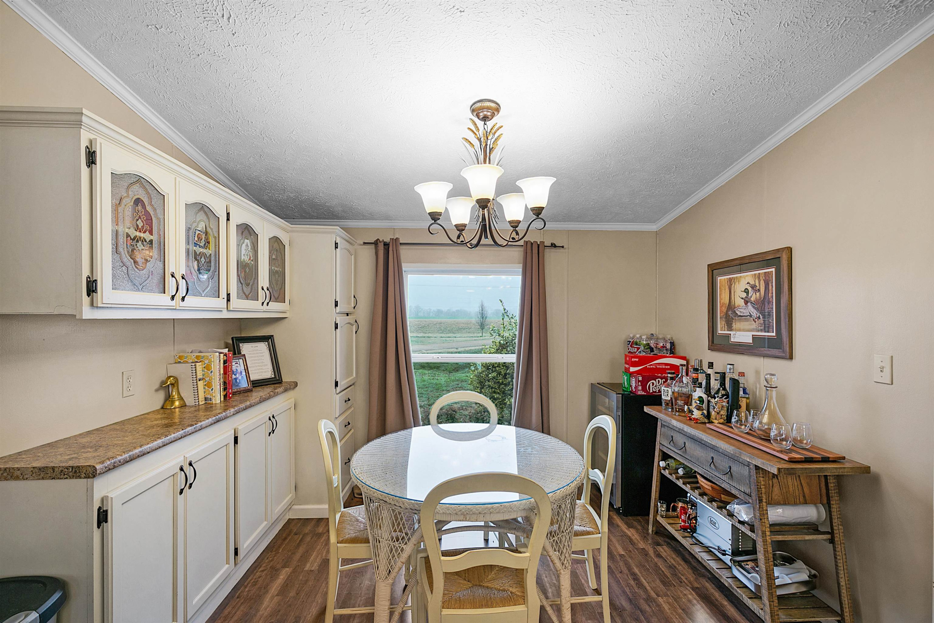 4022 Lower Jackson Road Bells, TN 38006 - Photo 11 of 18 a view of a dining room with furniture a chandelier and wooden floor