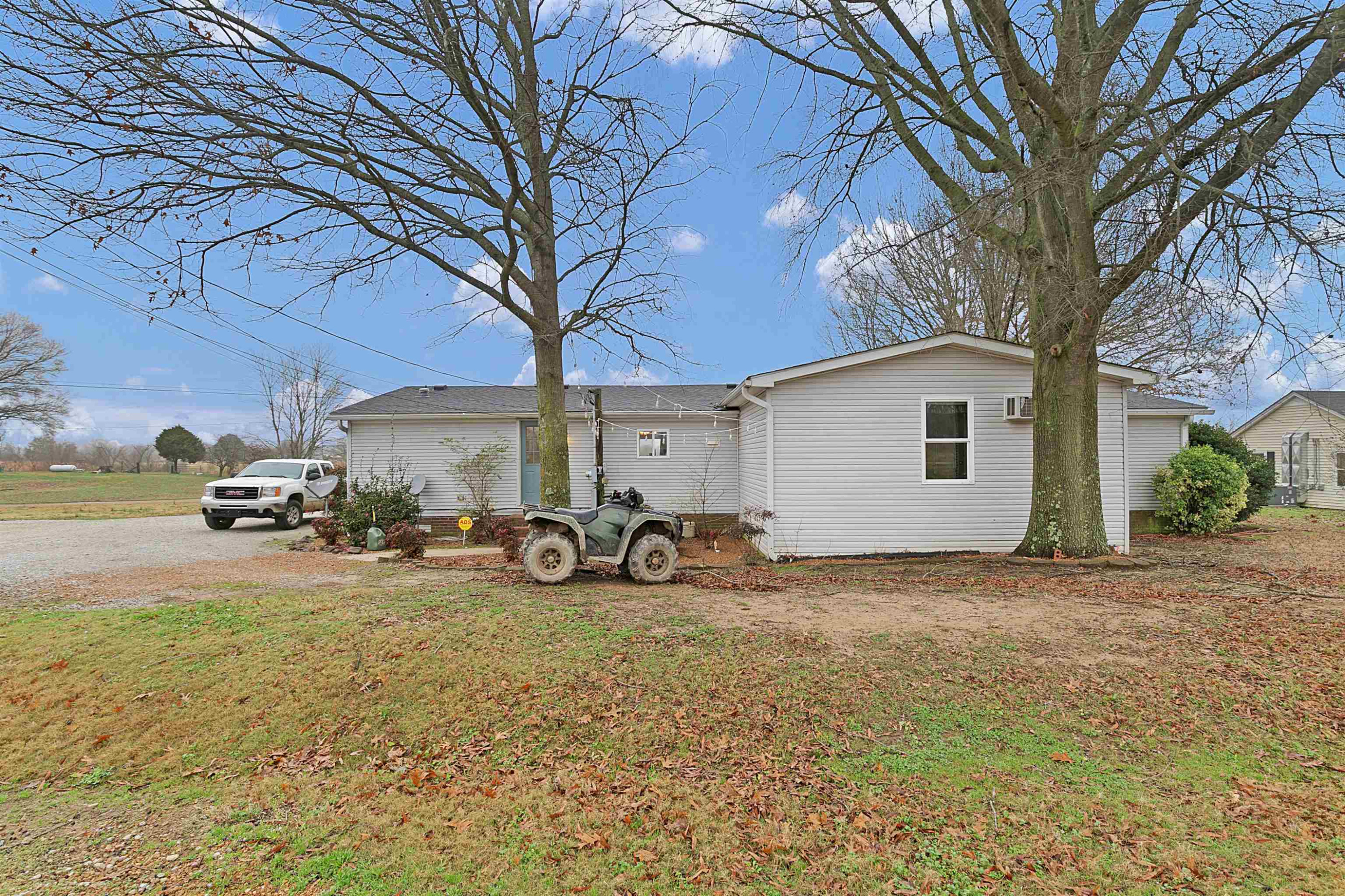 4022 Lower Jackson Road Bells, TN 38006 - Photo 4 of 18 a view of a backyard with table and chairs and a large tree