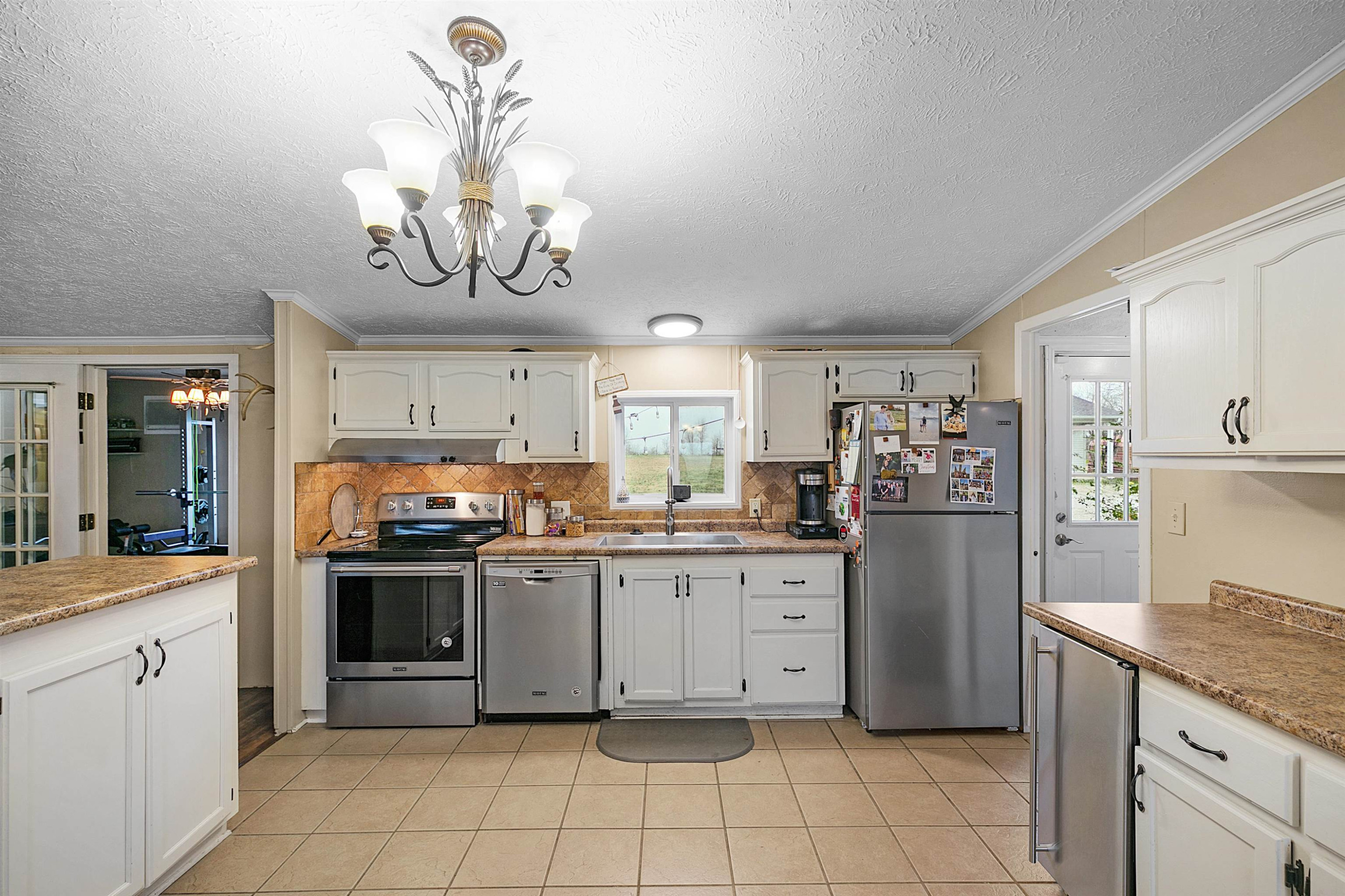 4022 Lower Jackson Road Bells, TN 38006 - Photo 10 of 18 a kitchen with stainless steel appliances granite countertop a stove top oven a sink dishwasher and a refrigerator