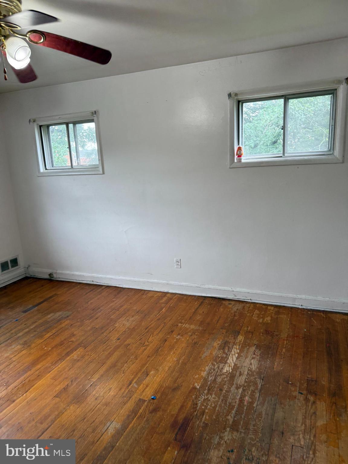 3901 Mortimer Avenue Baltimore, MD 21215 - Photo 13 of 21 an empty room with wooden floor and windows