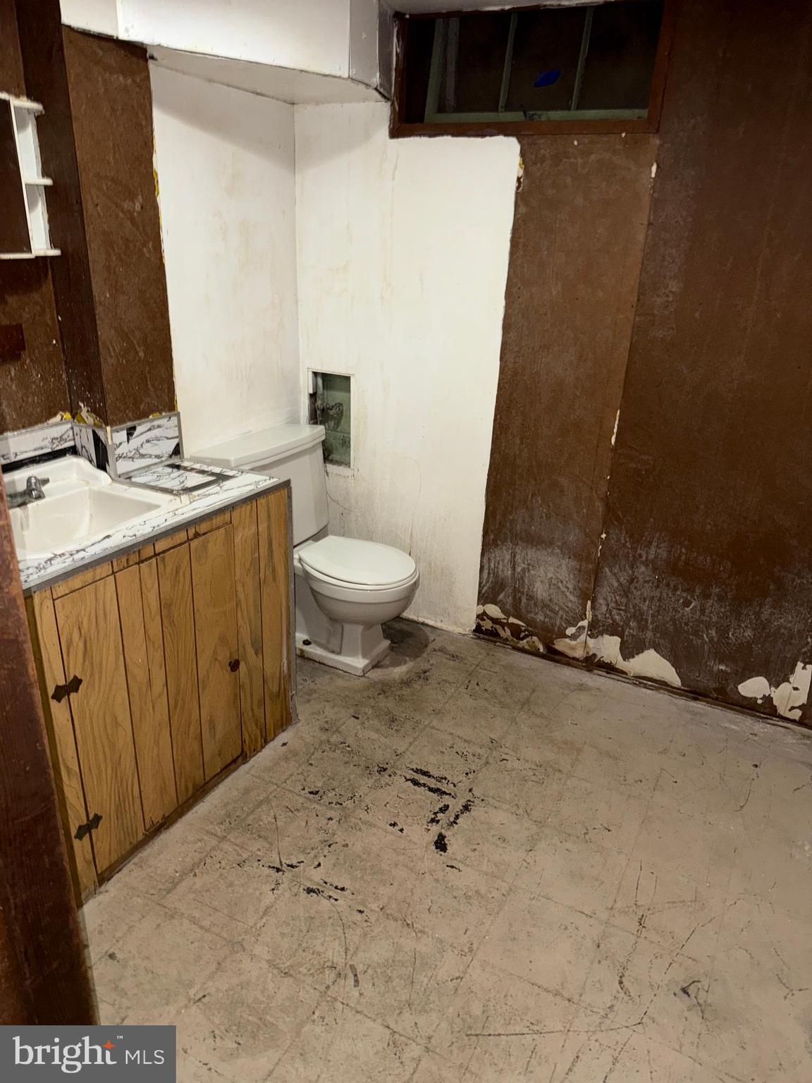 3901 Mortimer Avenue Baltimore, MD 21215 - Photo 17 of 21 a bathroom with a sink a toilet and a mirror