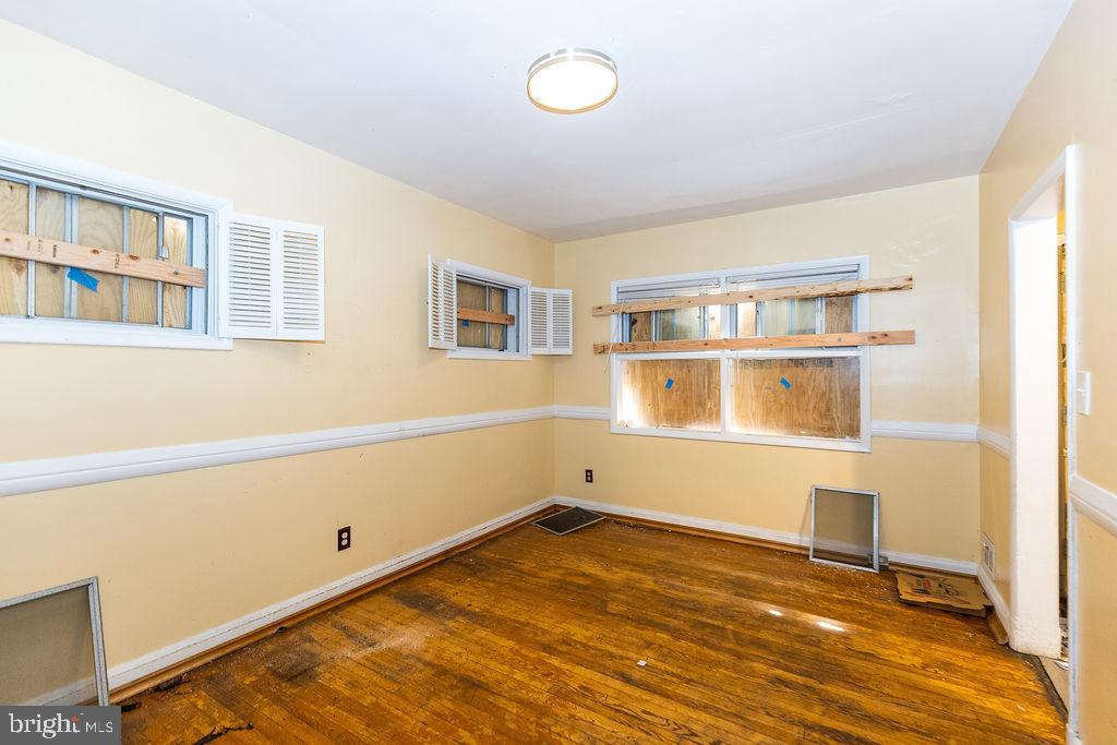 3901 Mortimer Avenue Baltimore, MD 21215 - Photo 5 of 21 a room with a wooden floor and white walls