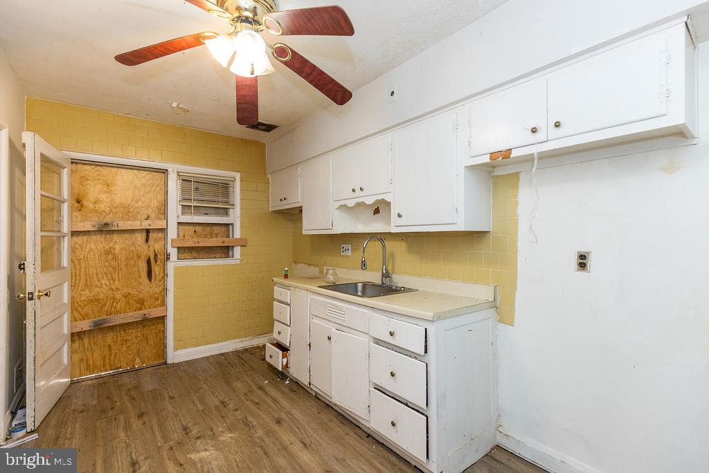 3901 Mortimer Avenue Baltimore, MD 21215 - Photo 6 of 21 a kitchen with a stove a sink and cabinets