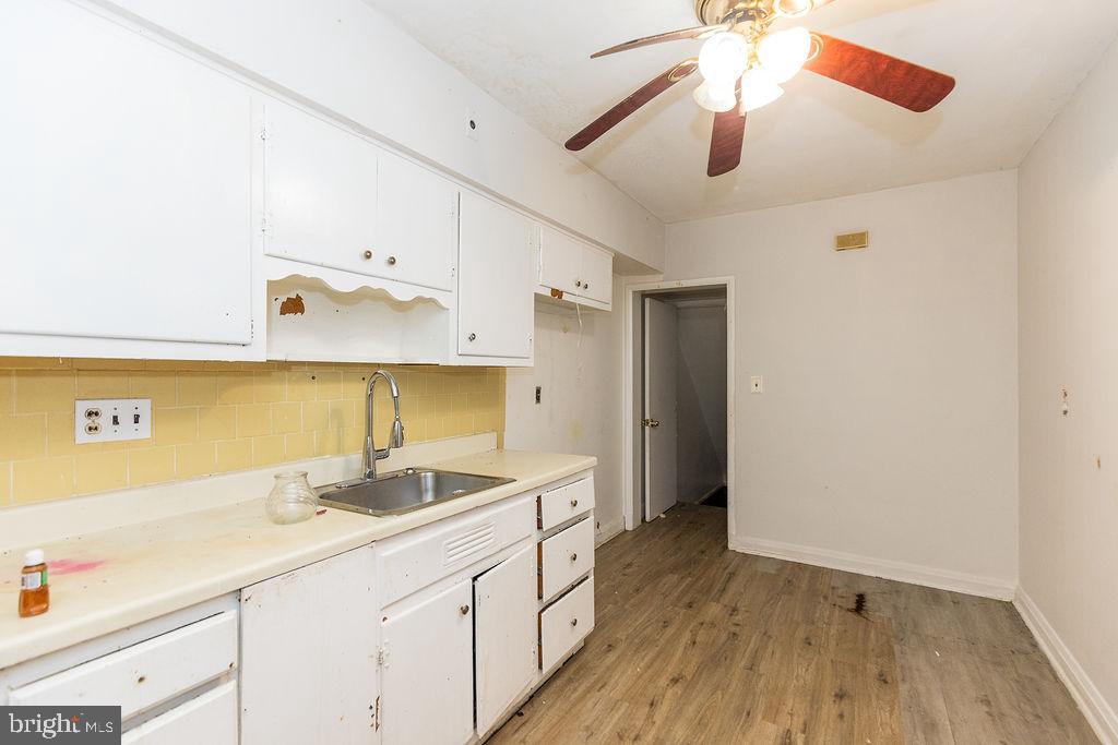 3901 Mortimer Avenue Baltimore, MD 21215 - Photo 7 of 21 a kitchen with a sink cabinets and wooden floor