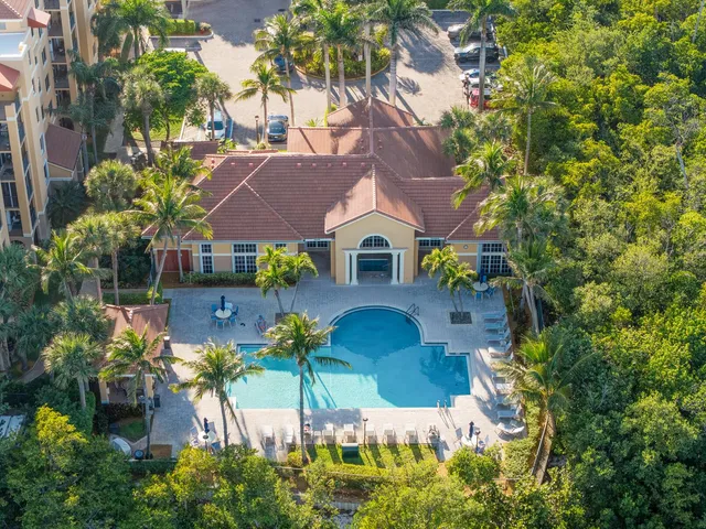 an aerial view of a house with a yard and garden