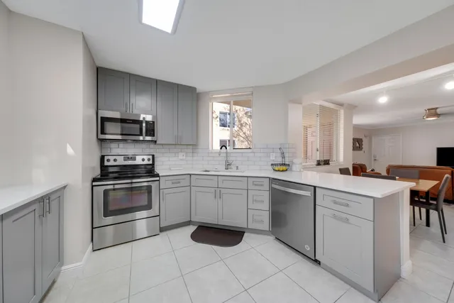 a kitchen with a sink cabinets and stainless steel appliances