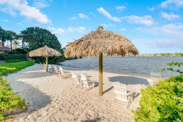 a table and chair under an umbrella in front of house
