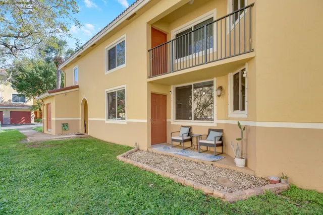 a house view with a sitting space and garden