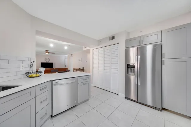 a kitchen with a sink and refrigerator