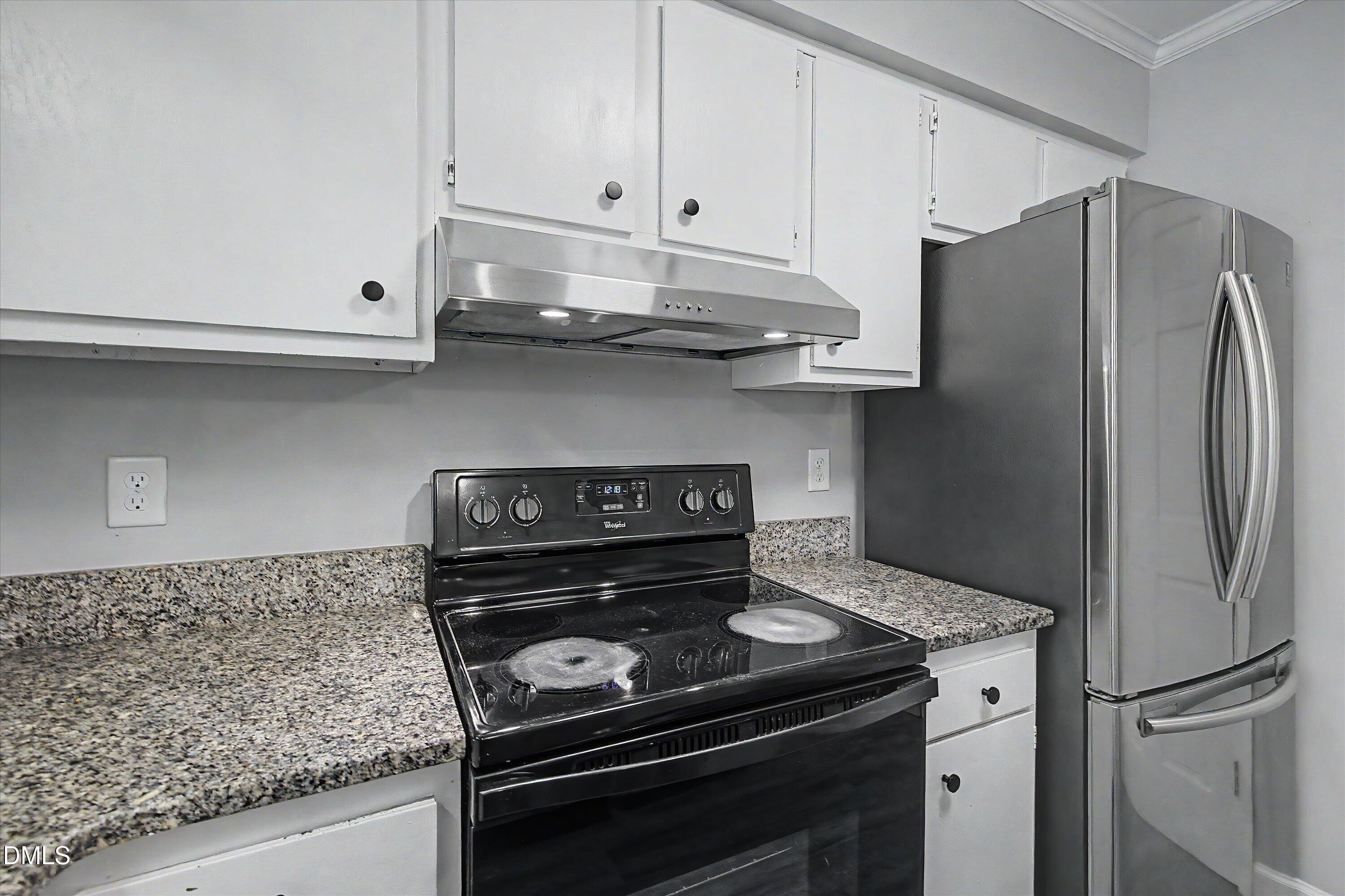 5519 Hamstead Crossing Raleigh, NC 27612 - Photo 16 of 33 a kitchen with granite countertop a stove and a refrigerator