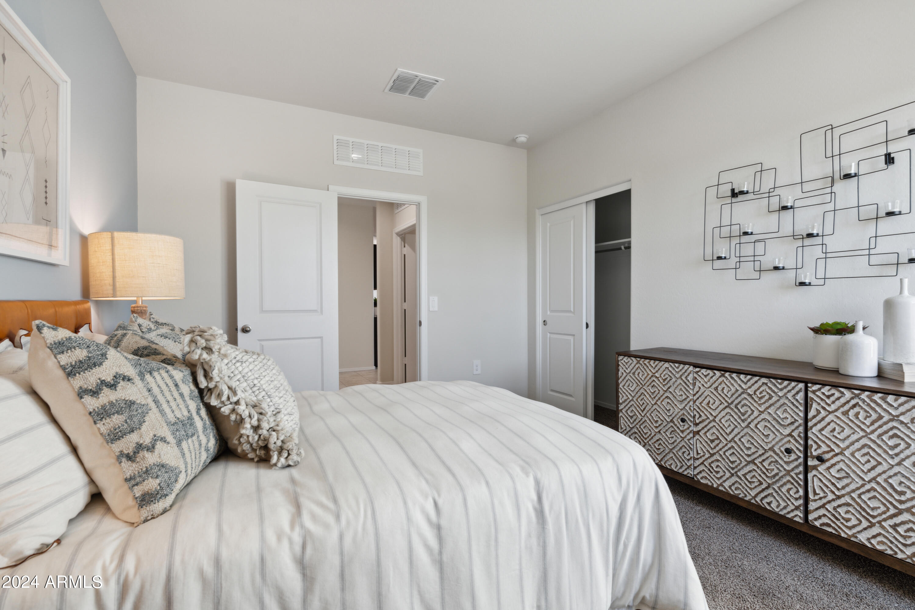 8522 West Gehrig Way Florence, AZ 85132 - Photo 11 of 46 a bedroom with a bed and painting on the wall