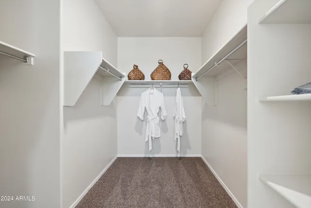 a living room with dining table chairs and a large window