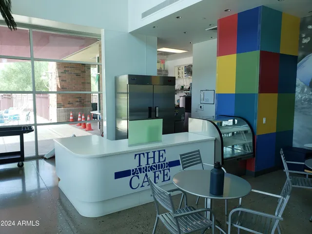 a swimming pool view with a seating space and a garden