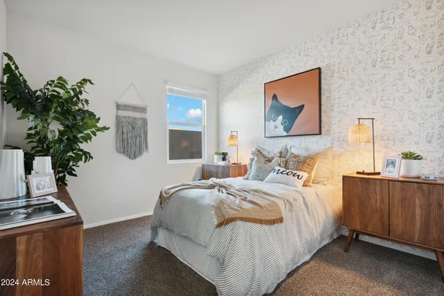 a bedroom with a bed and a night stand