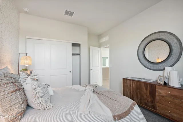 a bedroom with a bed and painting on the wall