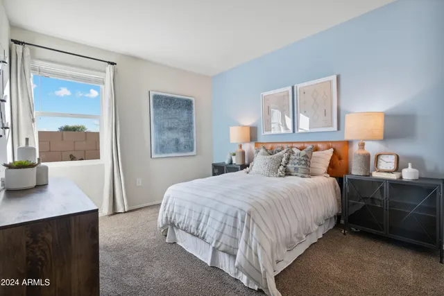 a bedroom with a bed and a mirror