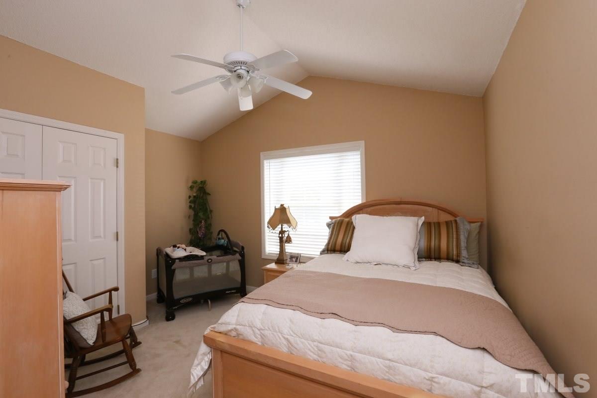 4033 Mantua Way Raleigh, NC 27604 - Photo 18 of 23 a bedroom with a bed and a chandelier