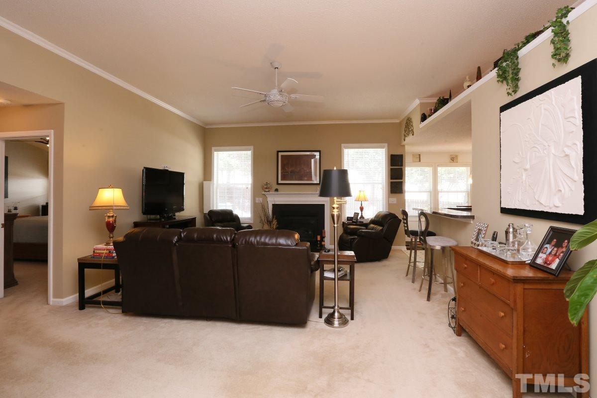 4033 Mantua Way Raleigh, NC 27604 - Photo 4 of 23 a living room with furniture a fireplace and a flat screen tv