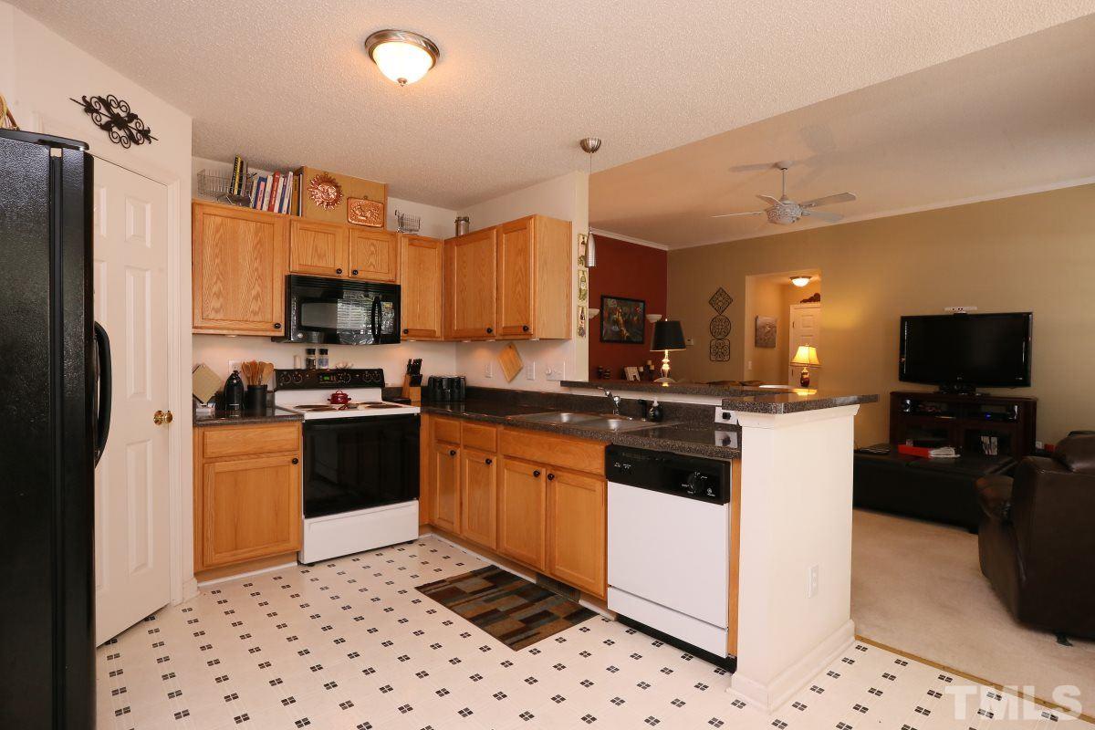 4033 Mantua Way Raleigh, NC 27604 - Photo 8 of 23 a kitchen with stainless steel appliances a refrigerator sink stove microwave and cabinets