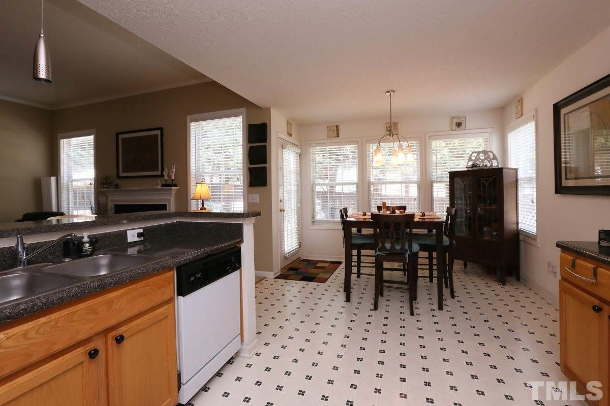 4033 Mantua Way Raleigh, NC 27604 - Photo 10 of 23 a kitchen with granite countertop a sink stove and refrigerator