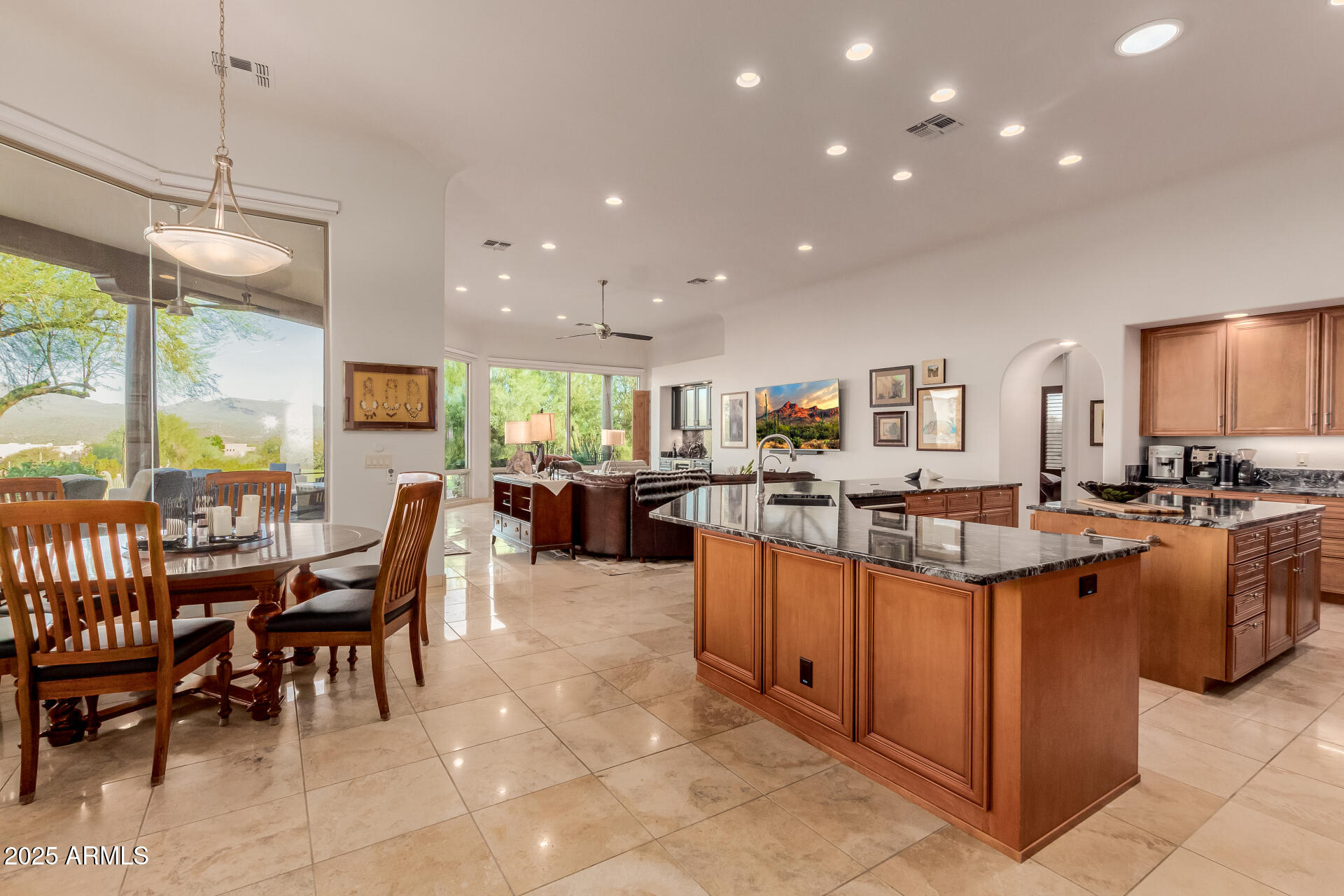 27609 Desierto Drive Rio Verde, AZ 85263 - Photo 17 of 86 a kitchen with stainless steel appliances kitchen island granite countertop a table chairs and a view of living room