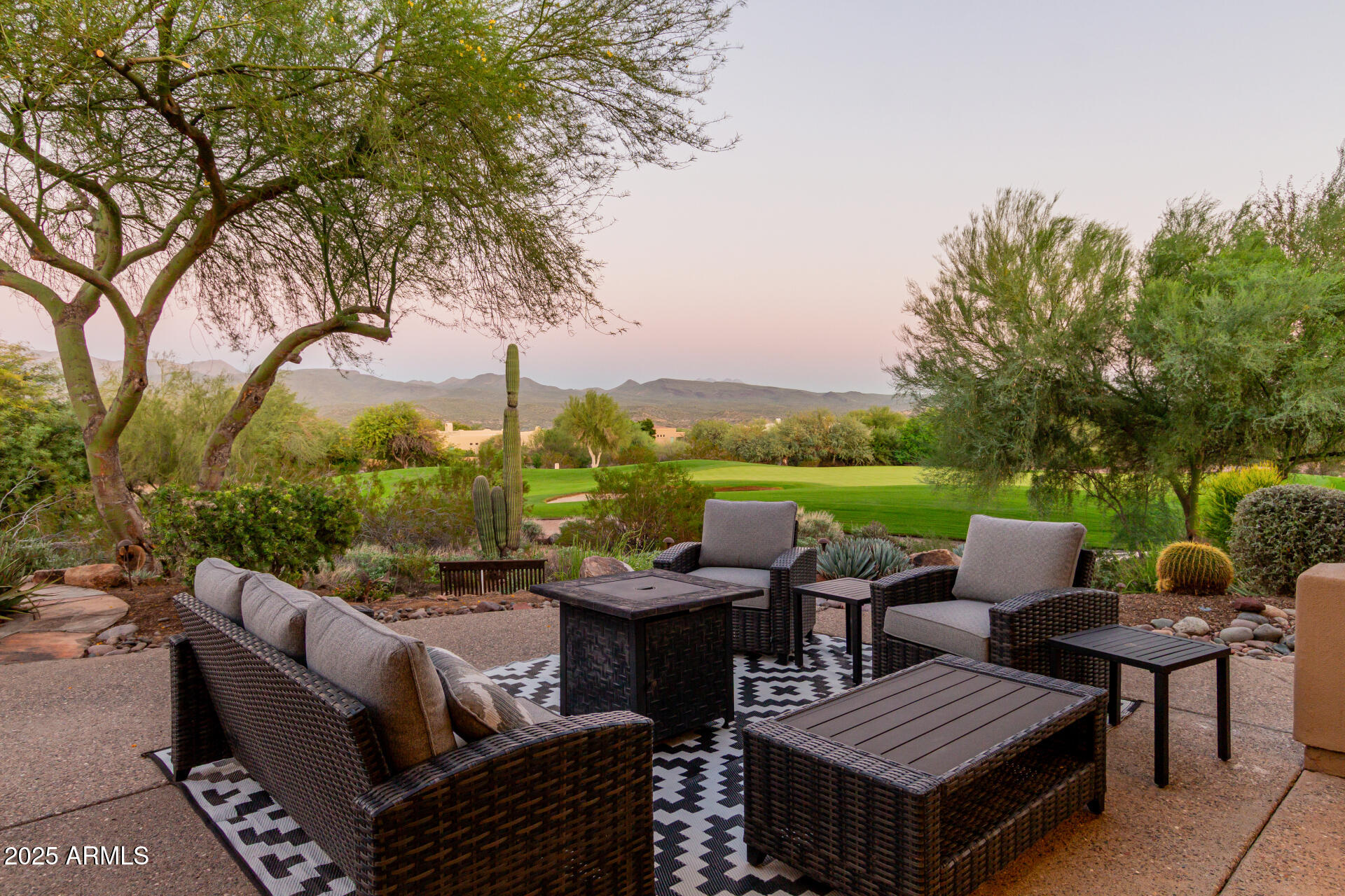 27609 Desierto Drive Rio Verde, AZ 85263 - Photo 61 of 86 a view of a patio with couches chairs and a table and chairs with wooden floor and fence