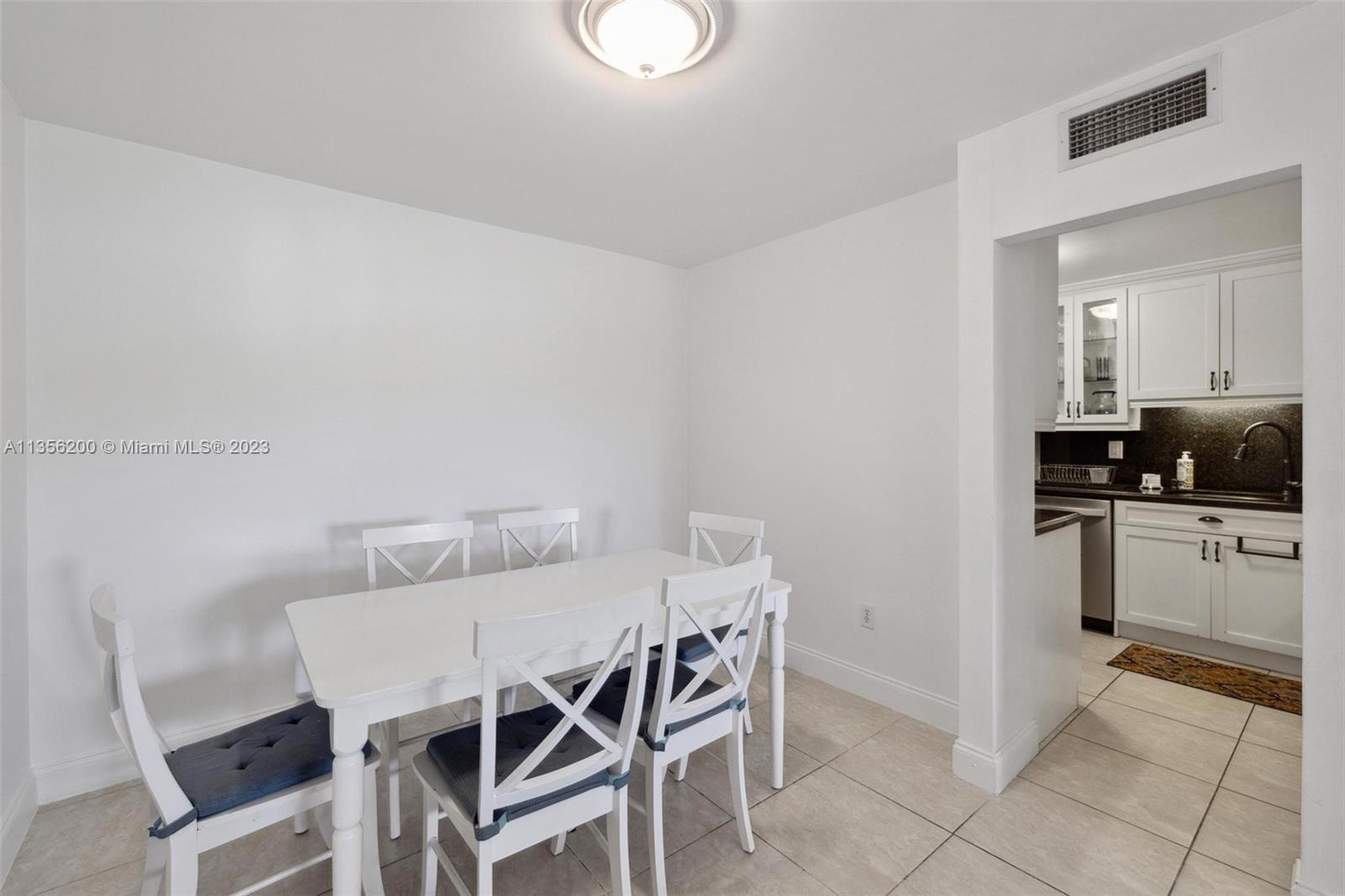 550 Ocean Drive, Unit 5C Key Biscayne, FL 33149 - Photo 11 of 21 a view of a dining room with furniture and kitchen view