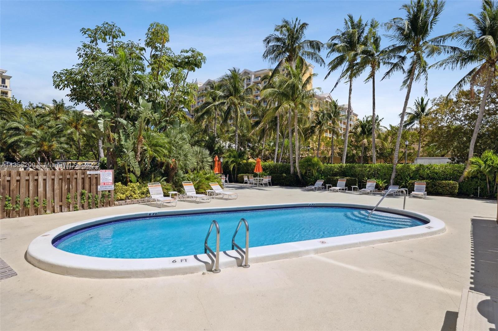 550 Ocean Drive, Unit 5C Key Biscayne, FL 33149 - Photo 12 of 21 a view of a swimming pool with a patio