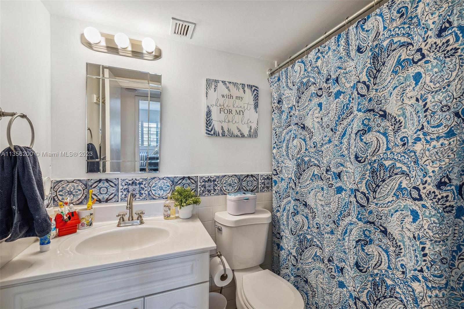 550 Ocean Drive, Unit 5C Key Biscayne, FL 33149 - Photo 18 of 21 a bathroom with a sink and a mirror