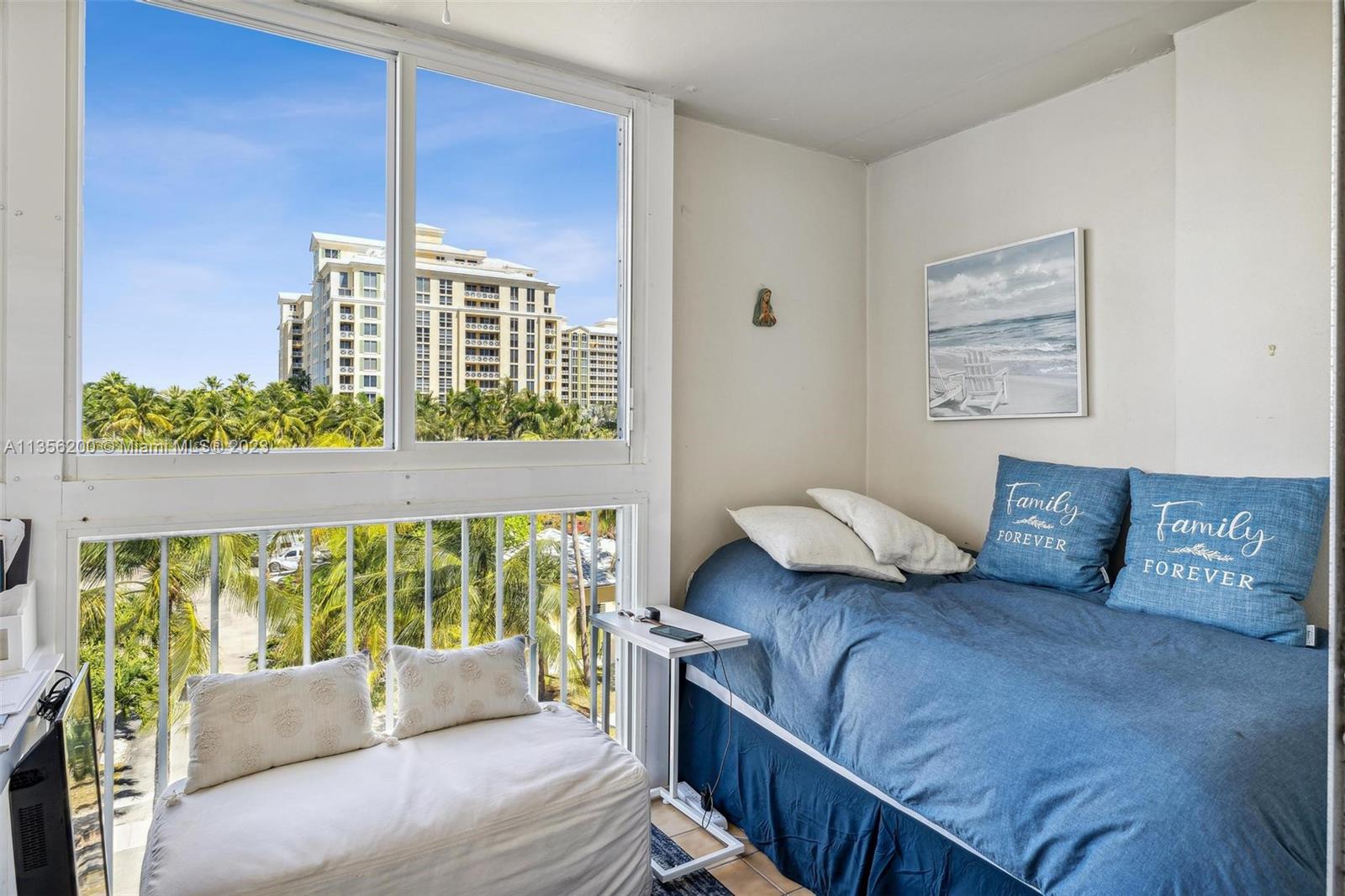 550 Ocean Drive, Unit 5C Key Biscayne, FL 33149 - Photo 9 of 21 a bedroom with furniture and a large window