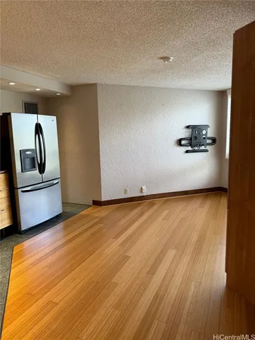 a view of a room with wooden floor and furniture