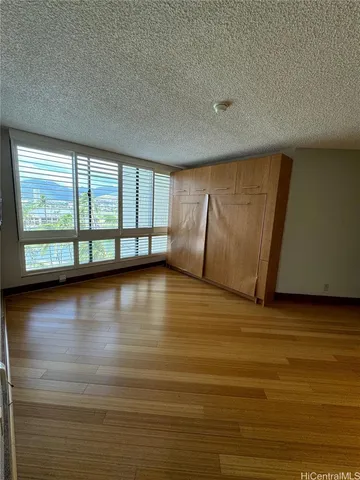 a view of a room with window and wooden floor