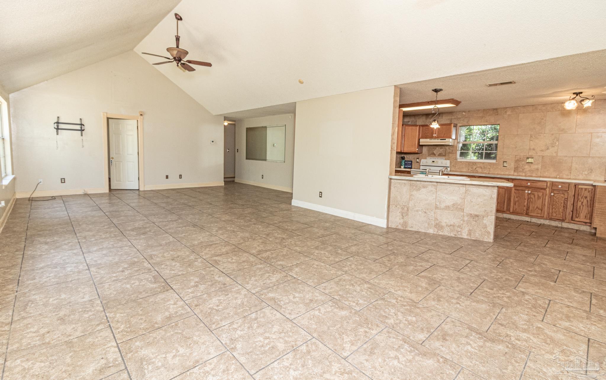 2394 Cove Road Navarre, FL 32566 - Photo 8 of 24 Overlooking Kitchen and Living Area from Dining Ar