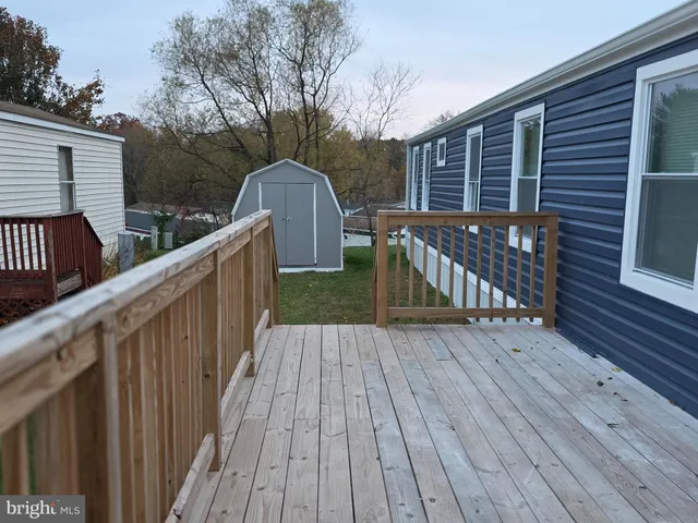 a view of deck with wooden floor and fence with a wooden floor