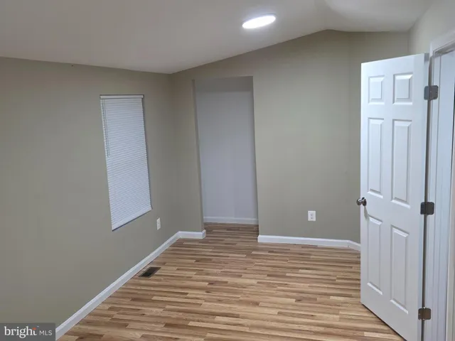 a view of a room with wooden floor and closet
