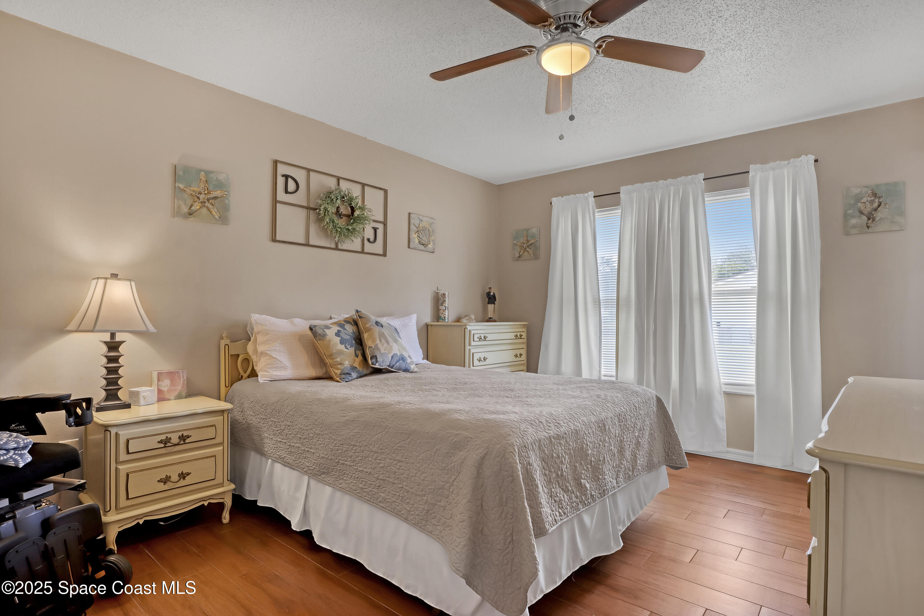 1513 Creel Road Northeast Palm Bay, FL 32905 - Photo 13 of 31 a bedroom with a bed and a chandelier