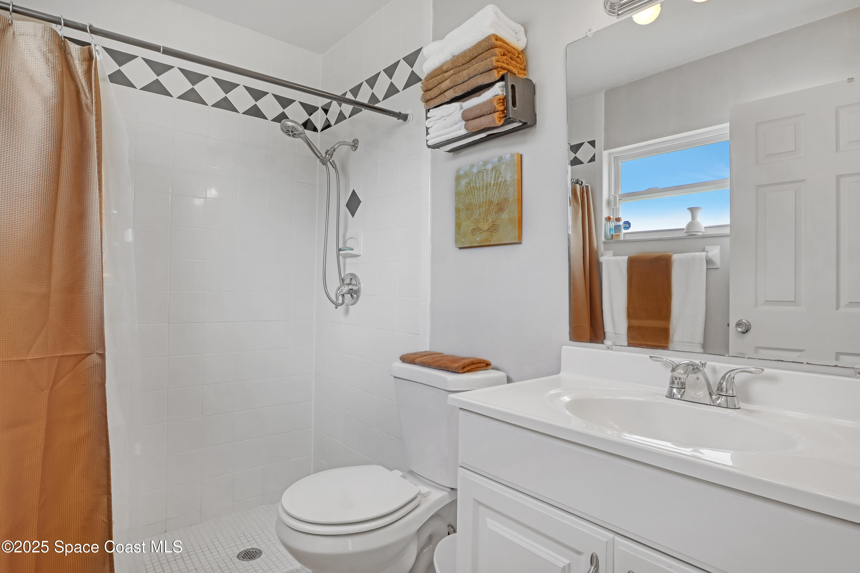 1513 Creel Road Northeast Palm Bay, FL 32905 - Photo 15 of 31 a bathroom with a sink toilet and shower