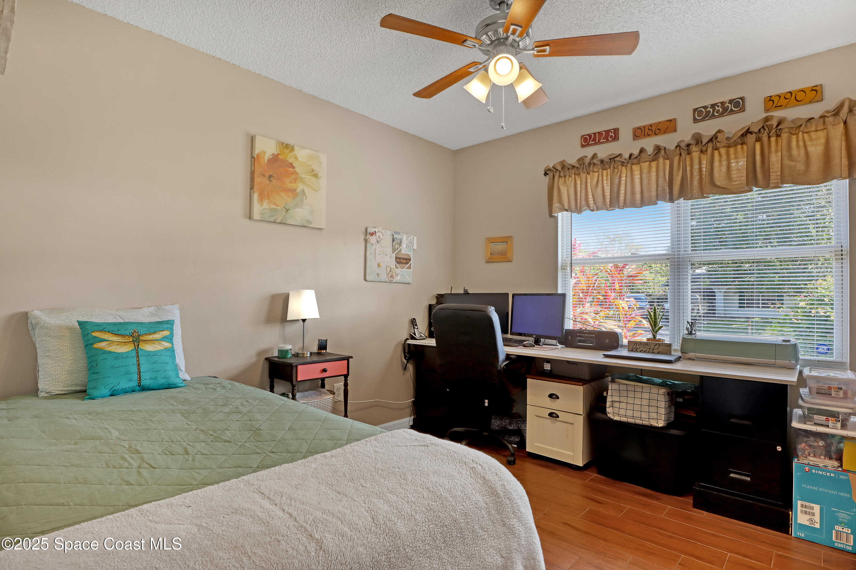 1513 Creel Road Northeast Palm Bay, FL 32905 - Photo 18 of 31 a bedroom with a bed and wooden floor