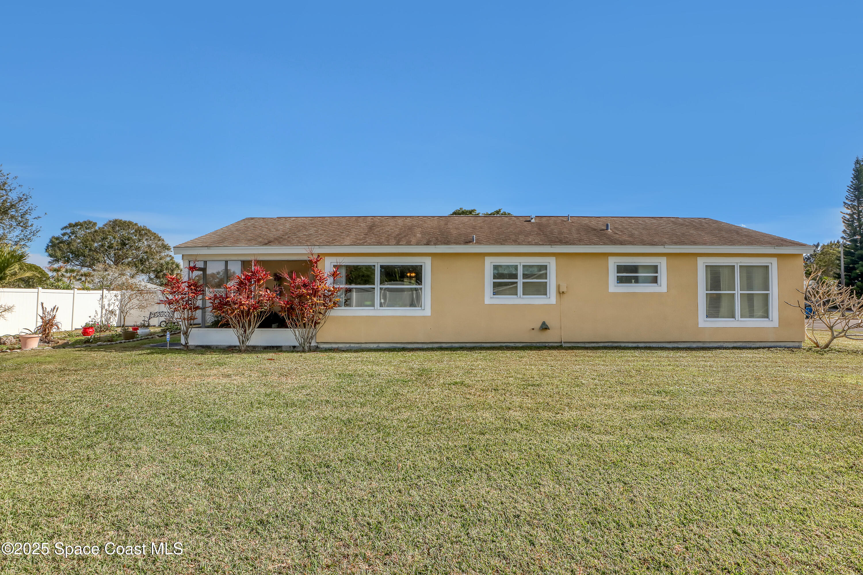 1513 Creel Road Northeast Palm Bay, FL 32905 - Photo 23 of 31 a front view of a house with a garden