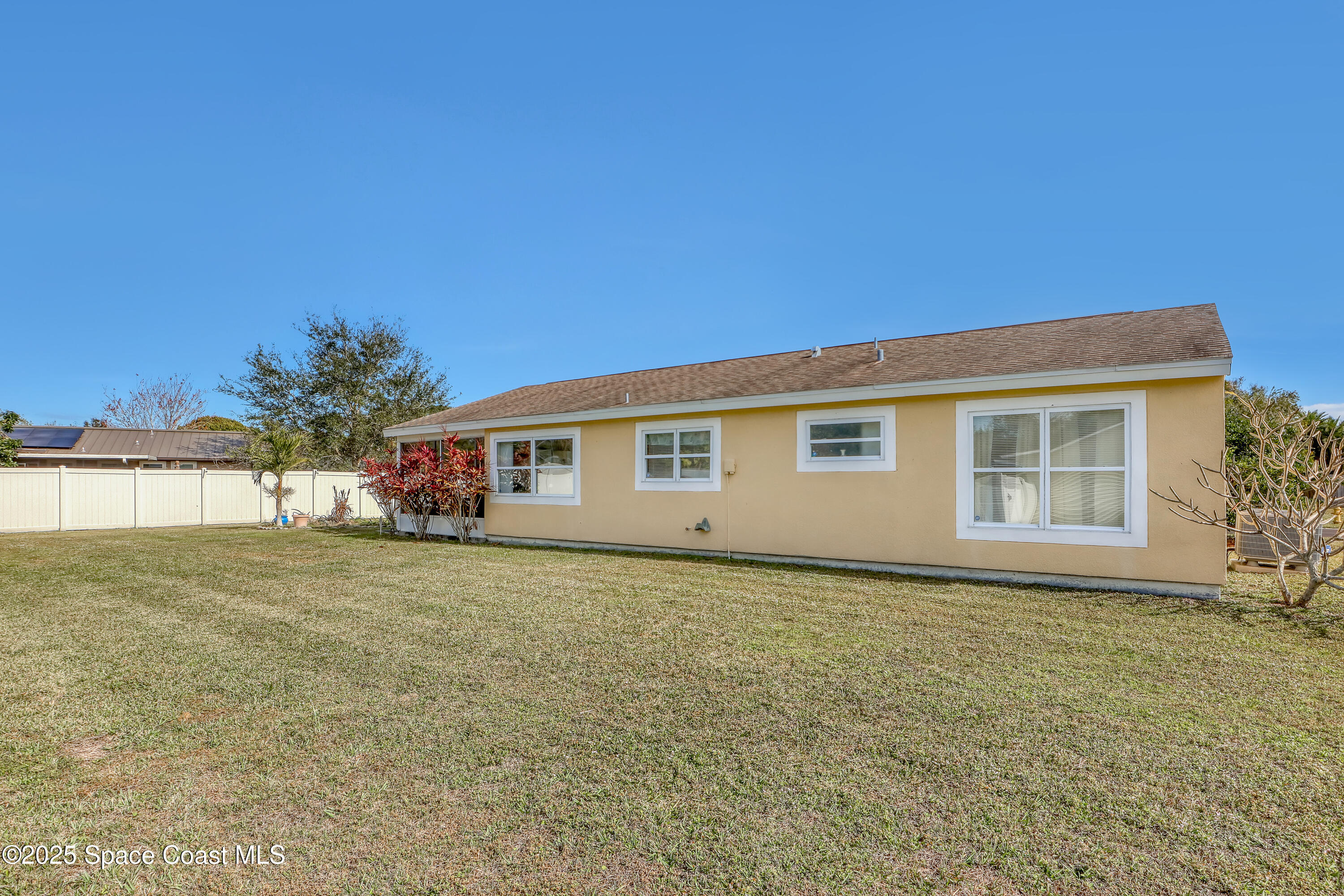 1513 Creel Road Northeast Palm Bay, FL 32905 - Photo 24 of 31 a front view of house with yard and trees