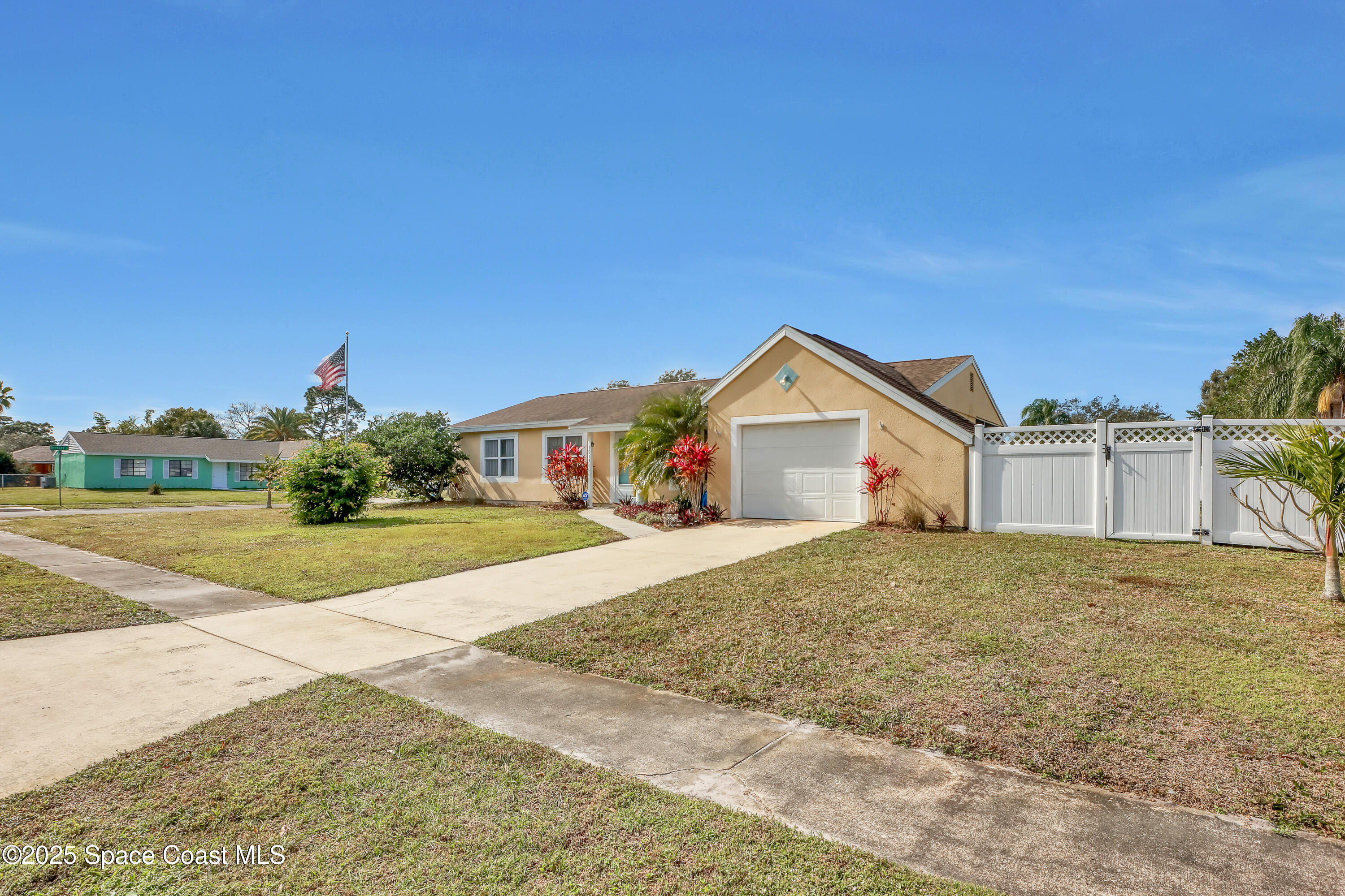 1513 Creel Road Northeast Palm Bay, FL 32905 - Photo 29 of 31 a front view of a house with a yard and garage